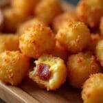 Golden bacon and Cheese-Stuffed Tater Tots on a platter.
