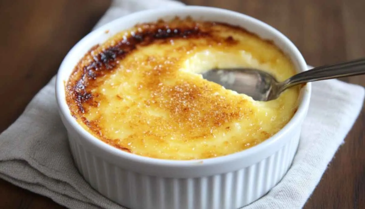 Classic crème brûlée in ramekin with cracked sugar crust