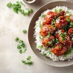 Irresistible sweet chili chicken served with rice and garnished with green onions