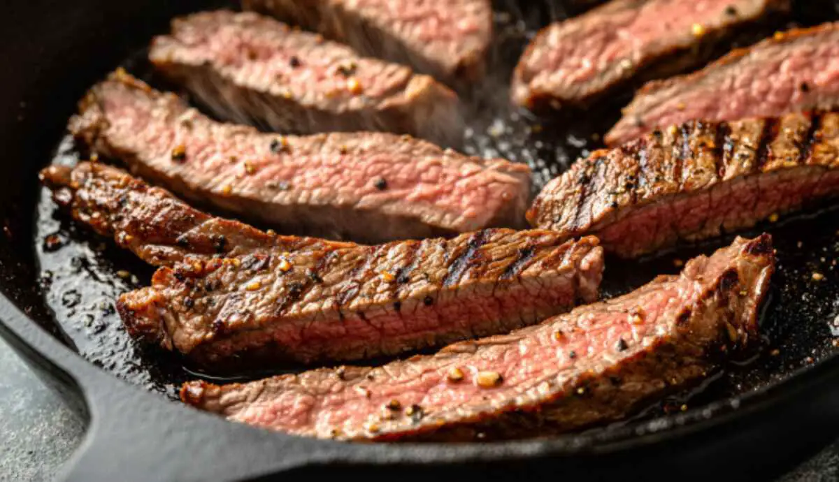 Steak strips searing in skillet for dirty fry burrito filling